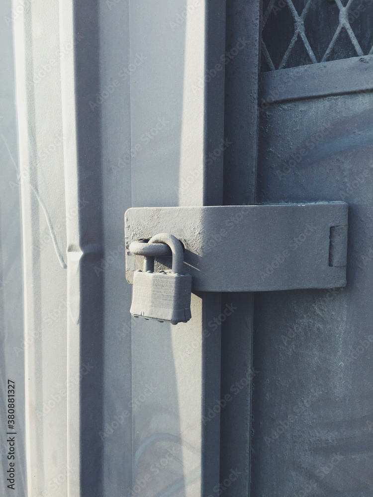 Padlock on metal warehouse door