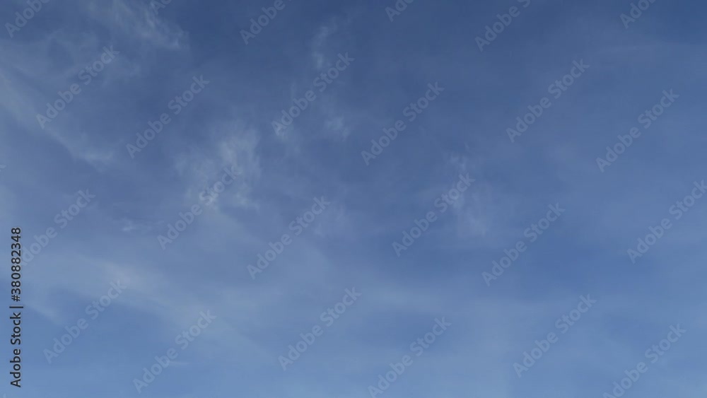 Fluffy wispy smoke cloud & cirrus or cirrostratus cloudscape moving on pastel blue sky background in tropical summer sunlight & sun rays at sunny daylight sunshine day, dramatic B-roll TimeLapse Fluffy wispy smoke cloud & cirrus or cirrostratus cloudscape moving on pastel blue sky background in tropical summer sunlight & sun rays at sunny daylight sunshine day, dramatic B-roll TimeLapse