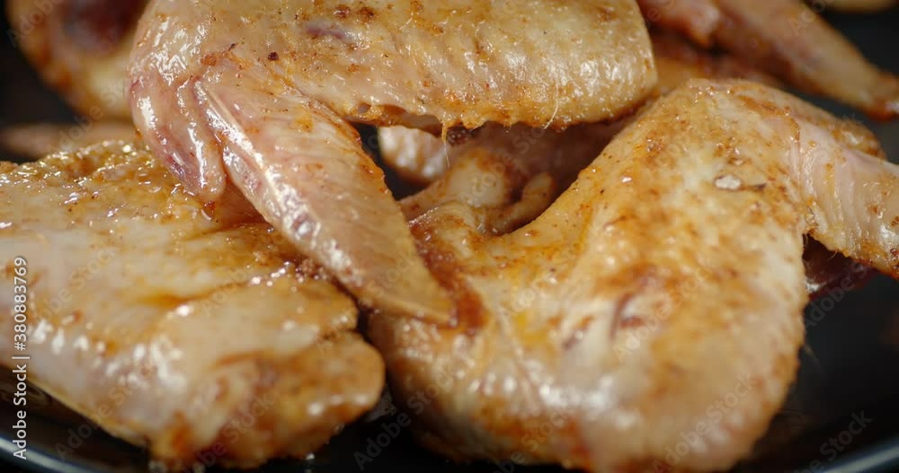 The plate with fried chicken wings rotates slowly. The plate with fried chicken wings rotates slowly.