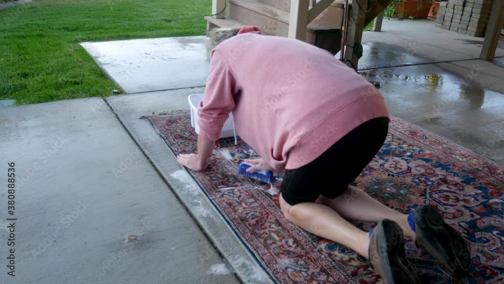 Hand scrubbing an oriental or Persian carpet with soap and water static shot Stock Video