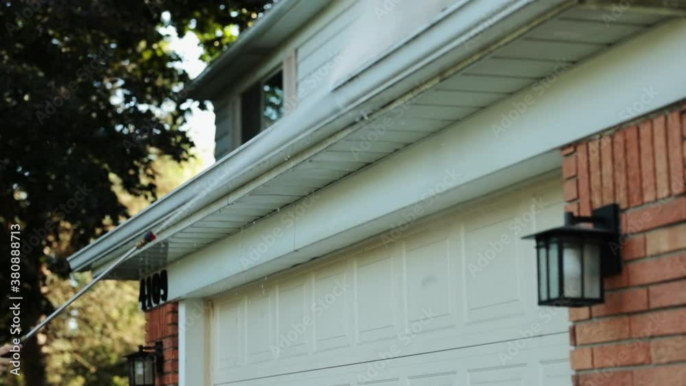 Slow-Motion Power Washer Pushing Dirt From House Gutter Slow-Motion Power Washer Pushing Dirt From House Gutter