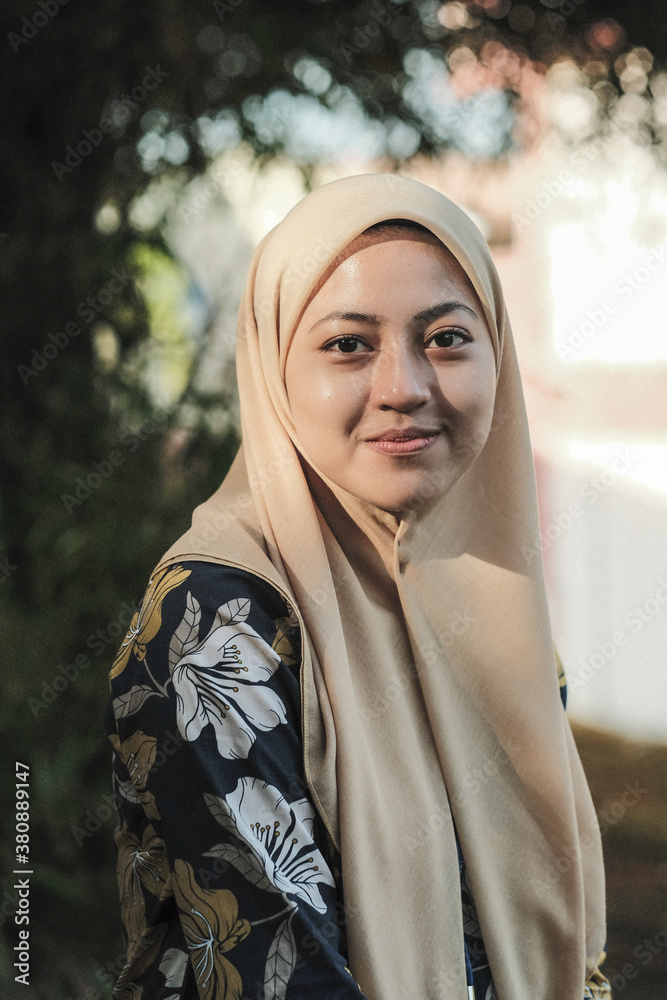 Portrait of happy young muslim woman wearing cream hijab Portrait of happy young muslim woman wearing cream hijab