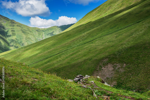 Alpine slopes of the mountains with textured grass surface