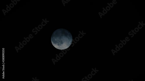 Timelapse of the moon dissapearing on the clouds. photo