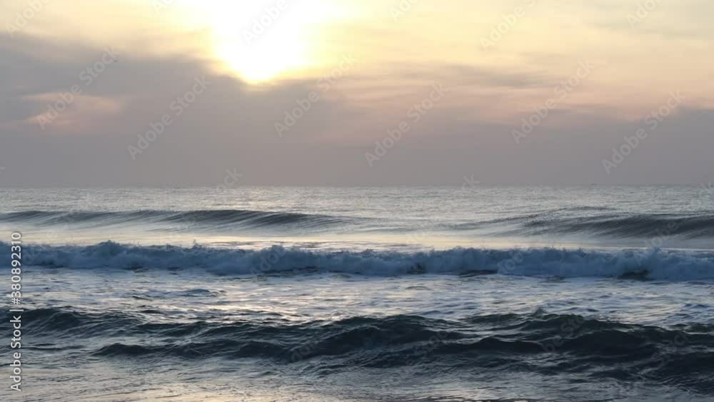 Beautiful natural view of the morning in which the sun rises with bright light and the rising of the mighty waves of the ocean,Yellow golden-colored clouds shining in the sky at sunrise landscape Beautiful natural view of the morning in which the sun rises with bright light and the rising of the mighty waves of the ocean,Yellow golden-colored clouds shining in the sky at sunrise landscape