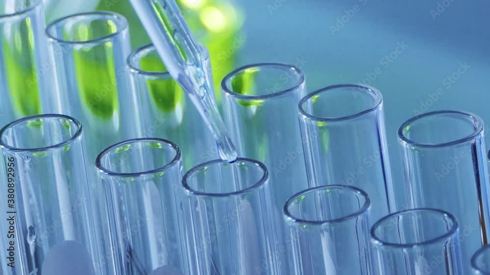 Scientist dropping chemical liquid to test tube, Blue tone laboratory. lab chemistry or science research and development concept. Scientist dropping chemical liquid to test tube, Blue tone laboratory. lab chemistry or science research and development concept.