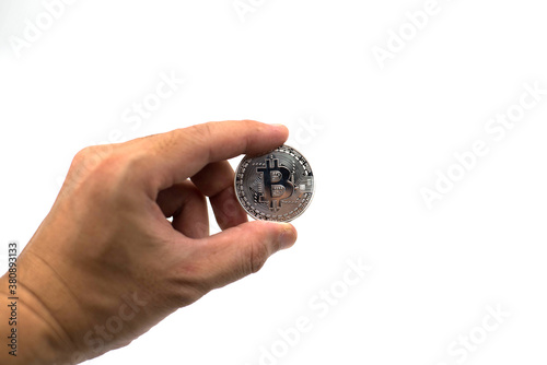 Silver bitcoin in hand isolated on white background.