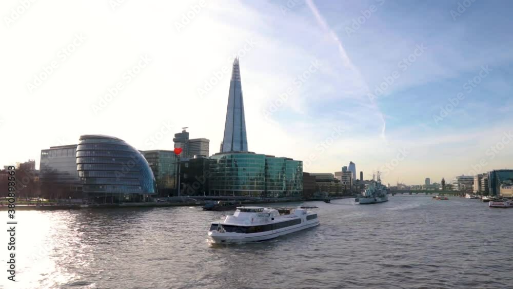 Panoramic view in slow motion of the Shard and City hall with a lovely heart balloon in London, United Kingdom, while a ship is passing by in the river Thames in clear daylight during the Spring. Panoramic view in slow motion of the Shard and City hall with a lovely heart balloon in London, United Kingdom, while a ship is passing by in the river Thames in clear daylight during the Spring.