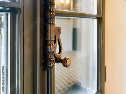 Brown window frame and modern window handle. Blurred background. © Анастасия Бурлакова