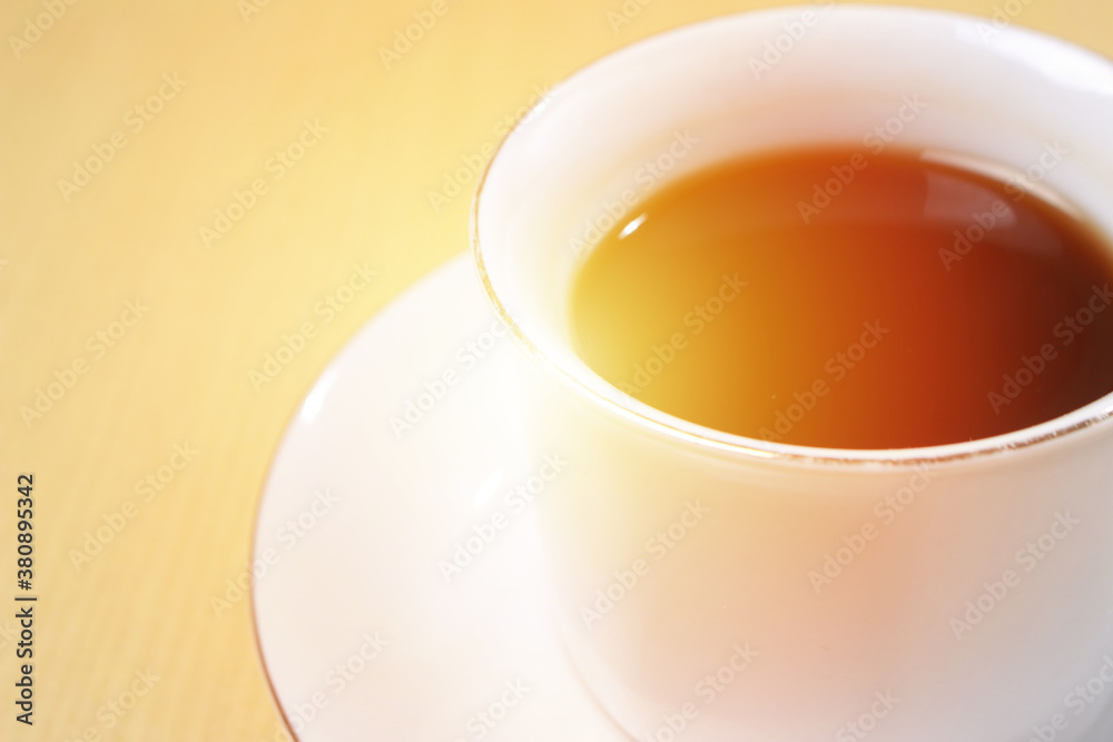 Close up image of coffee cup with sun light in the morning with copy space for text, time of coffee break Close up image of coffee cup with sun light in the morning with copy space for text, time of coffee break