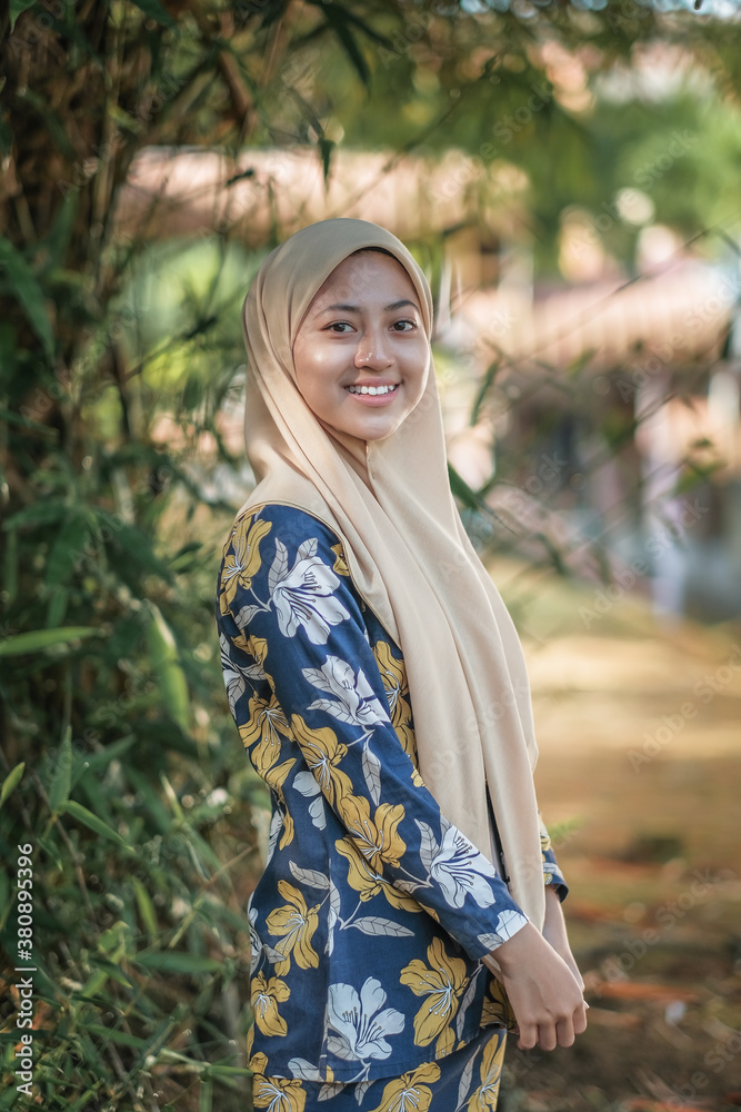 Portrait of happy young muslim woman wearing cream hijab Portrait of happy young muslim woman wearing cream hijab