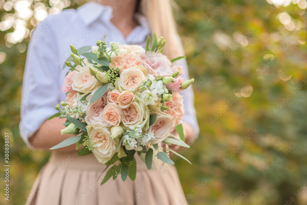 Wedding bouquet in bride hands. Roses, eustoma, eucalyptus in elegant bouquet . Summer and autumn flowers. Wedding bouquet in bride hands. Roses, eustoma, eucalyptus in elegant bouquet . Summer and autumn flowers.
