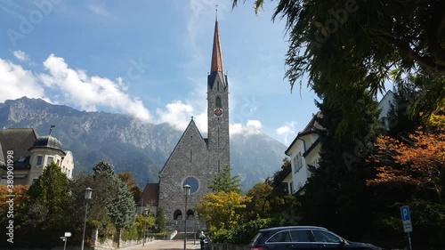 Church in the streets of Schaan in Liechtenstein. Moving from right to left on a sunny day. photo