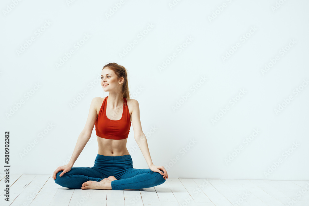 athletic woman in pose on the floor exercise gymnastics performance light background athletic woman in pose on the floor exercise gymnastics performance light background