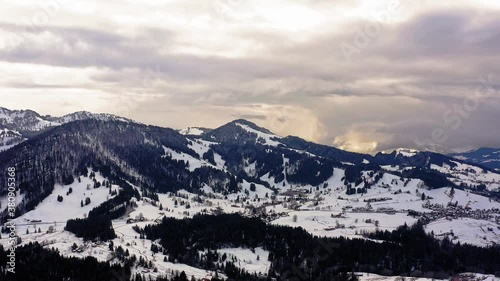 cloudy sky with colourd weather. Alps and hills in germany. smelting snow. Spring time, drone view photo