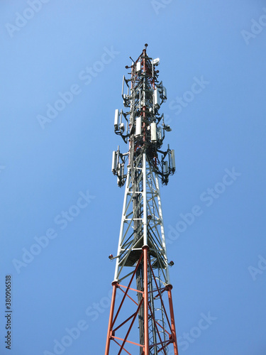 high cell tower against the blue sky