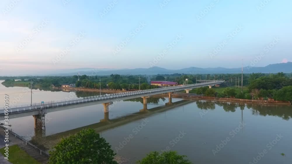 Aerial drone view of a bridge connecting communities along a river stream of Agno River in Pangasinan. Aerial drone view of a bridge connecting communities along a river stream of Agno River in Pangasinan.