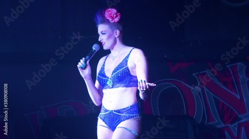 Scantily clad performer talks to audience during a performance