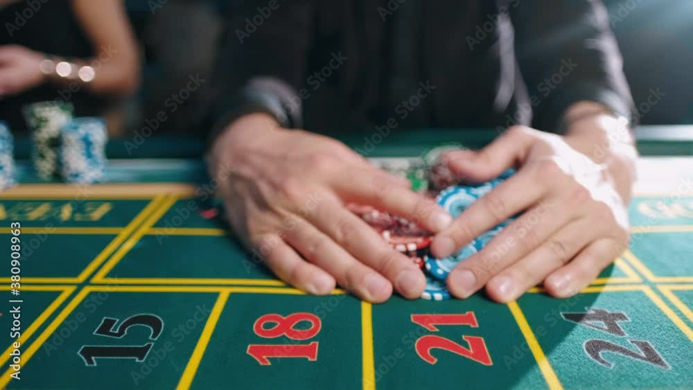 player takes a winning bet in a casino player takes a winning bet in a casino