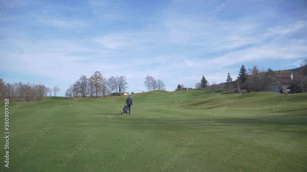 Golfer walking on beautiful Fairway with Bag Golfer walking on beautiful Fairway with Bag