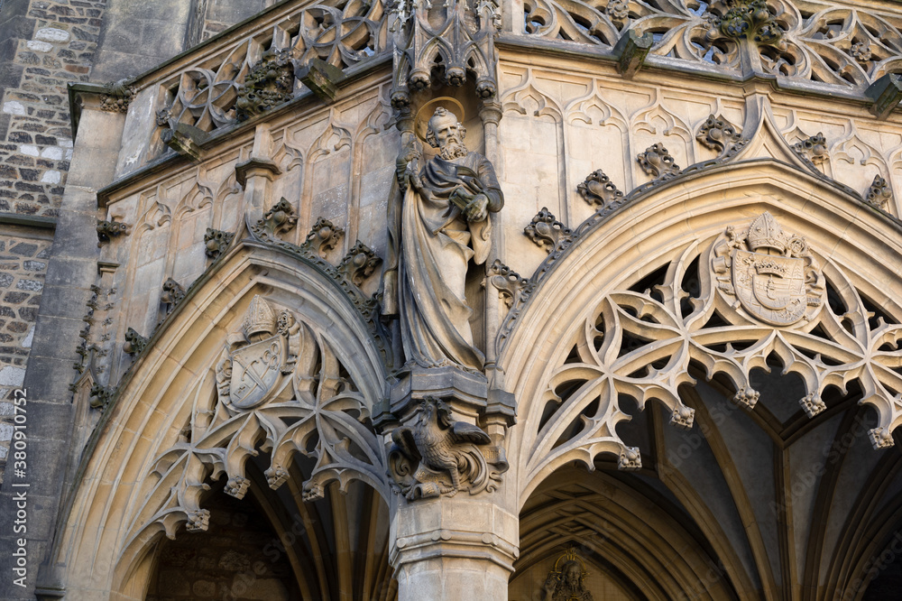 Detail of old historical building made in new gothic revival architecture style. Pointed gothic arch, statue, sculpture and decoration. Cathedral of saint Peter and Paul, Petrov, Brno. 