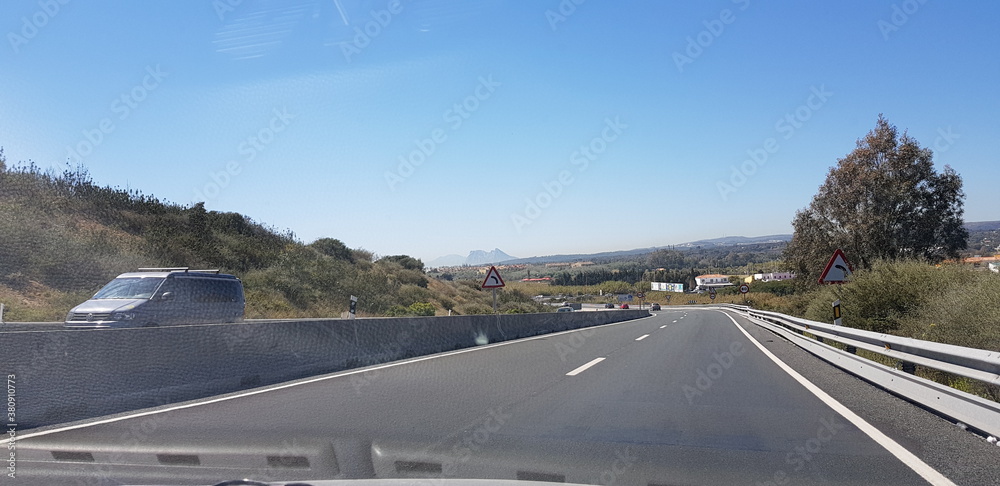 Fototapeta premium road, highway, sky, asphalt, travel, car, landscape, transportation, traffic, freeway, way, motorway, nature, transport, journey, blue, speed, clouds, drive, empty, line, street, lane, country, cars
