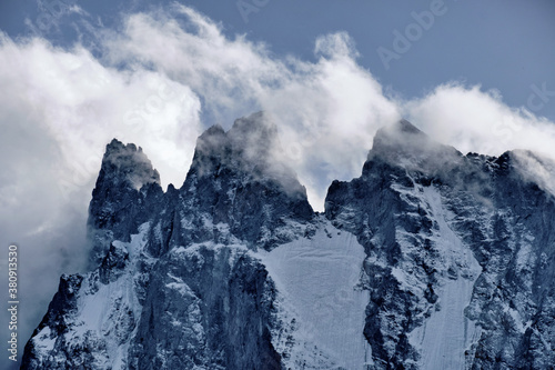 high mountains with glaciers in the clouds © Nikolai