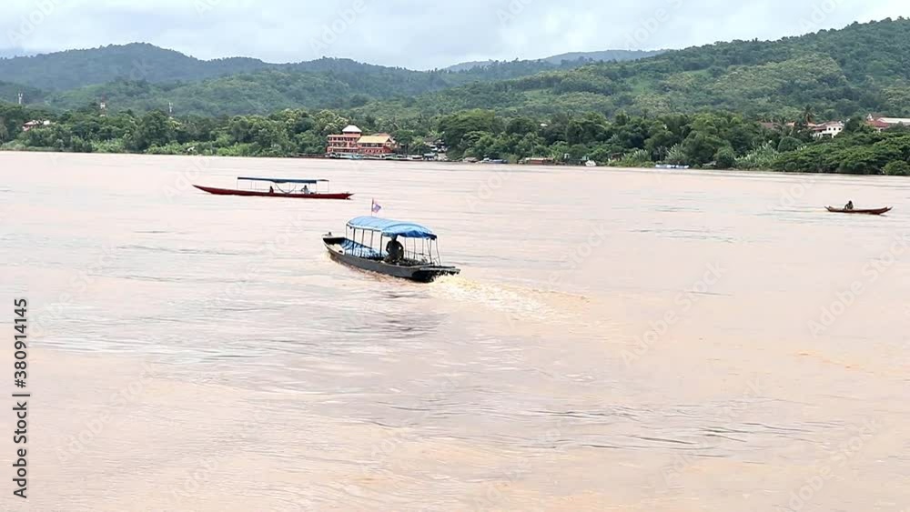 Two Long Boats on the Meekong river Chiang Kong Thailand Two Long Boats on the Meekong river Chiang Kong Thailand