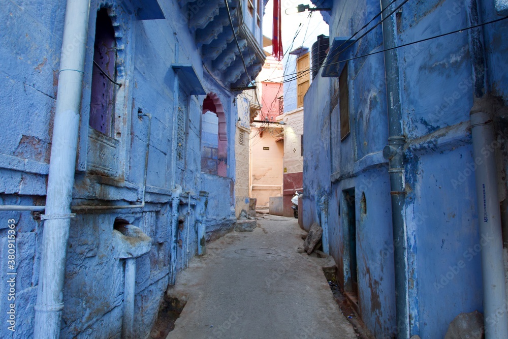 narrow street with blue houses in Jodhpur, Rajasthan, India narrow street with blue houses in Jodhpur, Rajasthan, India
