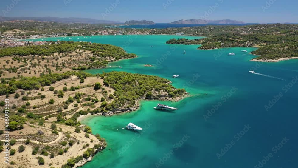 Aerial drone video of famous and picturesque yacht dock seaside fjord village of Porto Heli with turquoise and emerald clear waters, Argolida, Peloponnese, Greece Aerial drone video of famous and picturesque yacht dock seaside fjord village of Porto Heli with turquoise and emerald clear waters, Argolida, Peloponnese, Greece