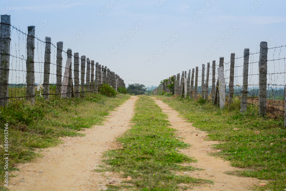 Rural mud road with fence