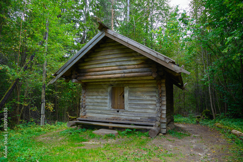Ancient northern russian wooden cabins and churches in the wood near the river