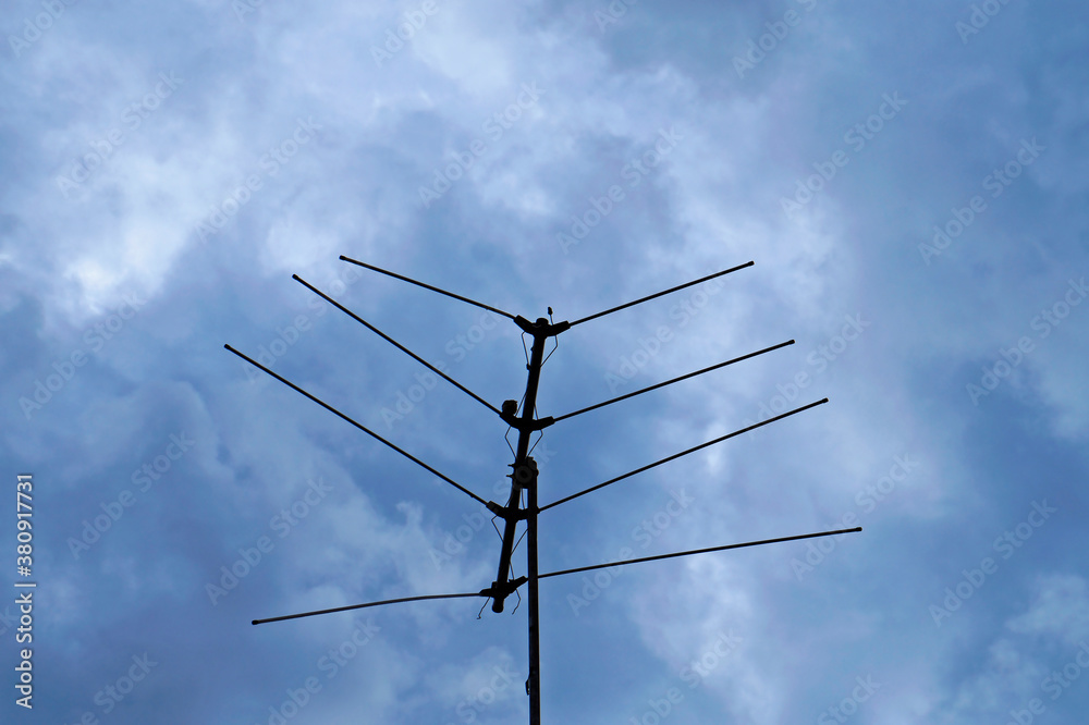 Old analog television antenna on cloudy sky background, Sao Joao del Rei, Brazil Old analog television antenna on cloudy sky background, Sao Joao del Rei, Brazil