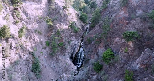 Flying overtop of a small waterfall while ascending in the drone. Waterfall located in British Columbia, Canada. photo