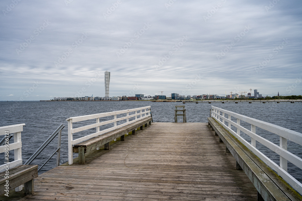 A wooden jetty with blue ocean and sky in the background. Picture from Malmo in southern Sweden