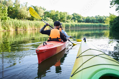 Back viewof couple kayaking on river