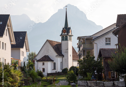 Elegant church in the middle of Morschach, Switzerland,  in morning sun. photo