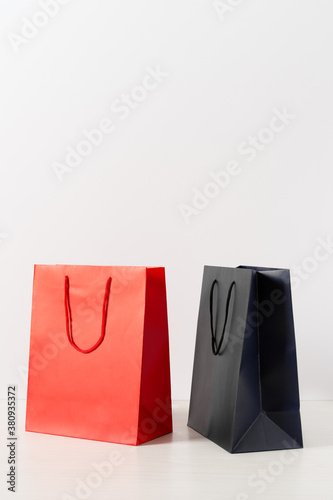 Group of colorful paper shopping bags over white background.