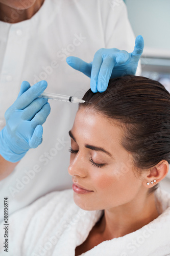 Woman receiving injection in the head zone