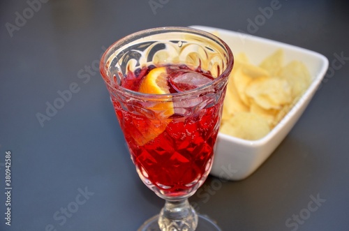Wallpaper Mural Campari soda cocktail on ice with a piece of orange  in a crystal glass, salty crackers nearby, blurred vintage background Torontodigital.ca