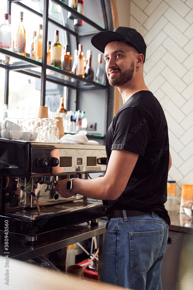 Fototapeta premium Male barista working on coffee machine