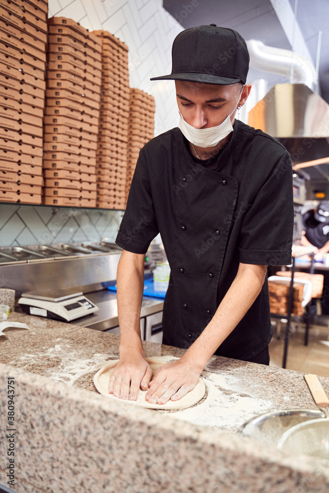 Pizzaiolo with prepearing dough for pizza Pizzaiolo with prepearing dough for pizza