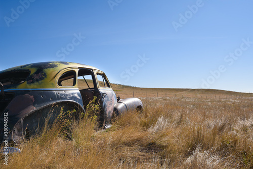 Fototapeta Naklejka Na Ścianę i Meble -  abandoned car on a dry  prairie landscape