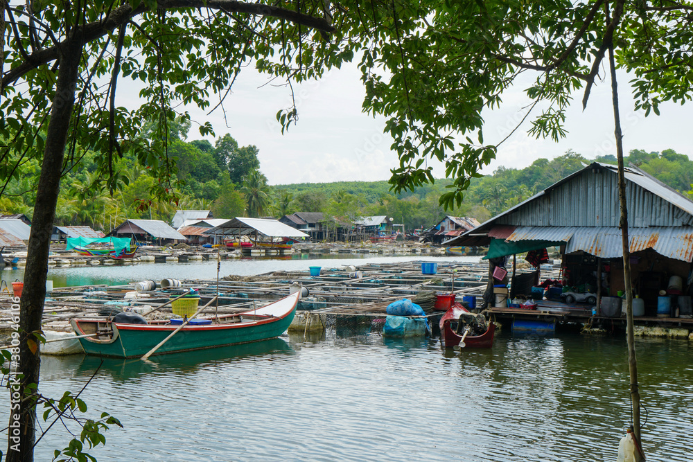 Fishing village in Thailand with boats and metal roofs. Fishing village in Thailand with boats and metal roofs.