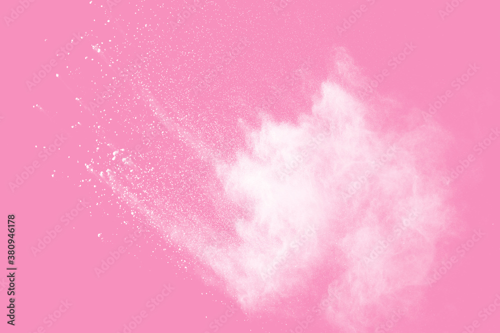 Fototapeta premium Abstract white powder explosion. Closeup of white dust particle splash isolated on pink background.