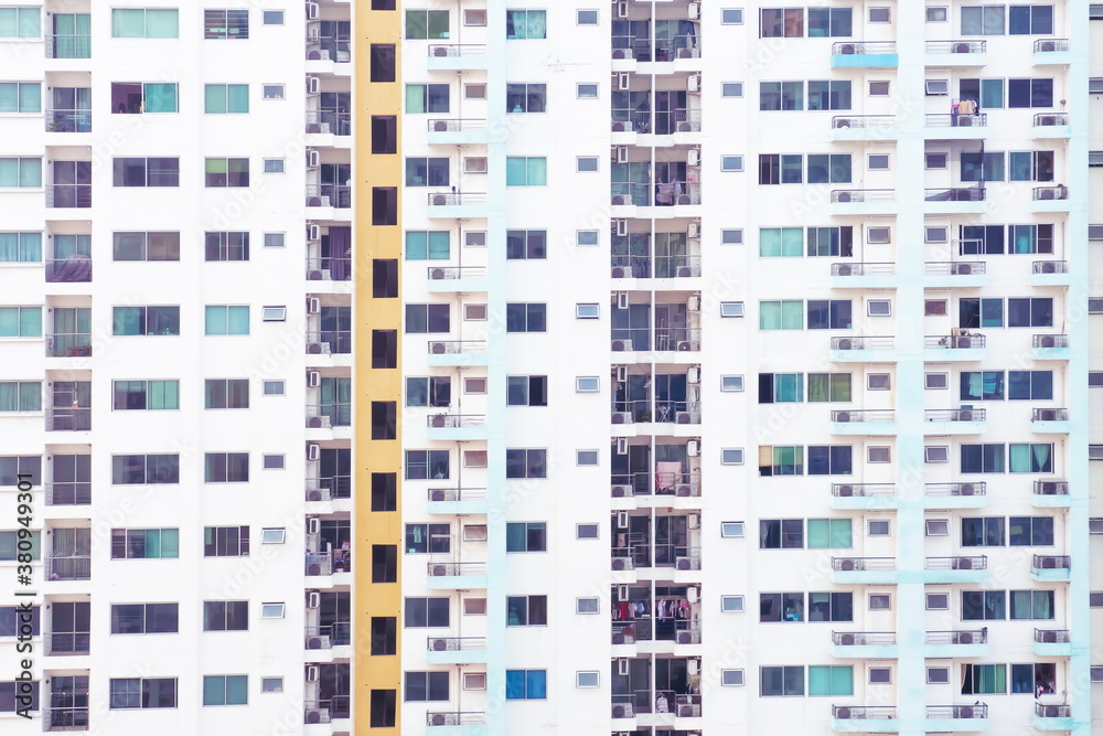 Exterior of the condominium many window scenes. The scene of a small crowded room of a tall condominium building. City life on tall buildings.