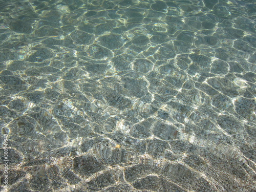 Sand beach. Transparent water, small waves.