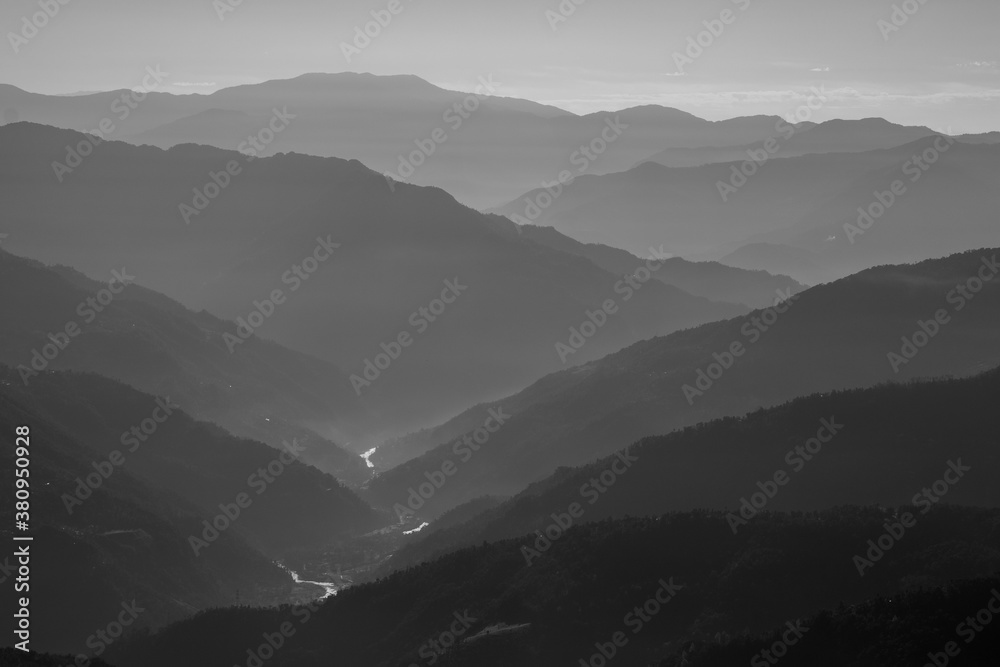Monochrome Silhouette of mountain ranges with a river flowing through them during an early morning at Sikkim India
