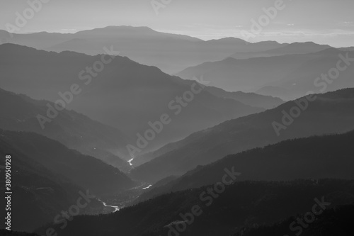 Monochrome Silhouette of mountain ranges with a river flowing through them during an early morning at Sikkim India 
