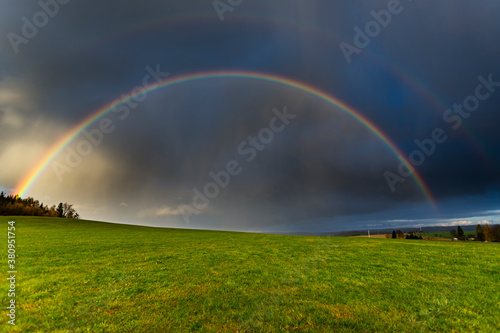Photos Dopple Rainbow, Thunderstorm is coming with rain, clouds are warm illuminated fr